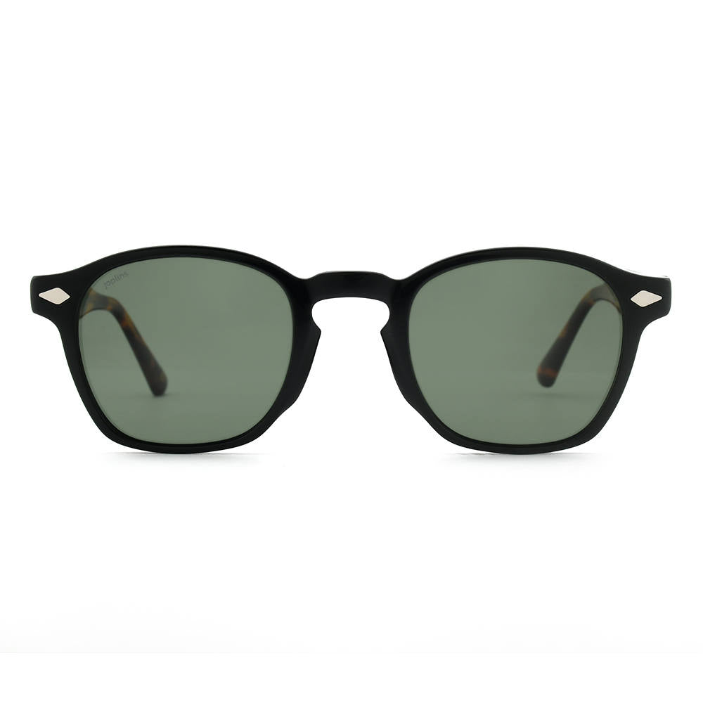 Black sunglasses with green lenses on a white background