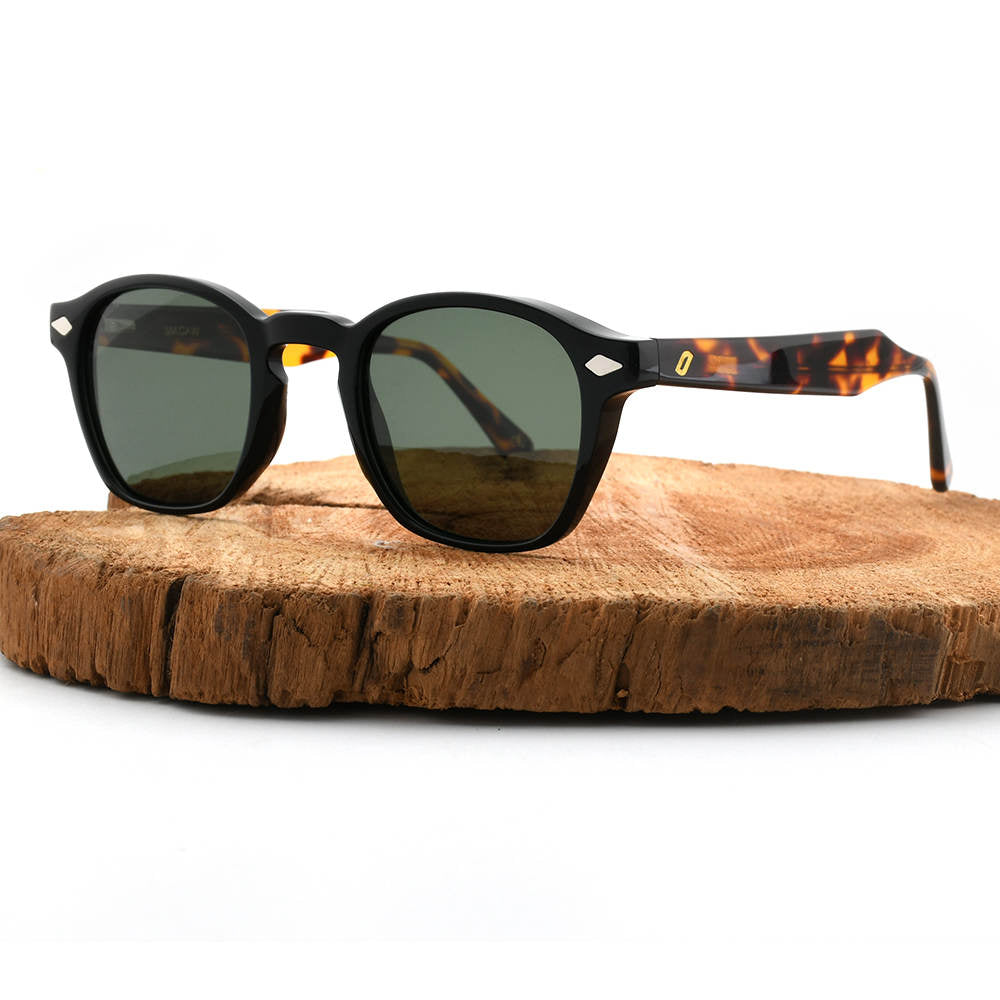 Sunglasses with tortoiseshell frame and dark lenses on a wooden surface